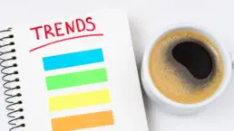 2022 trends business concept. Notebook with trends list, coffee